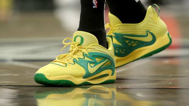 View of yellow and green Nike KD shoes.